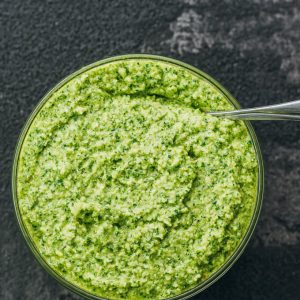 pesto sauce served in glass bowl with spoon