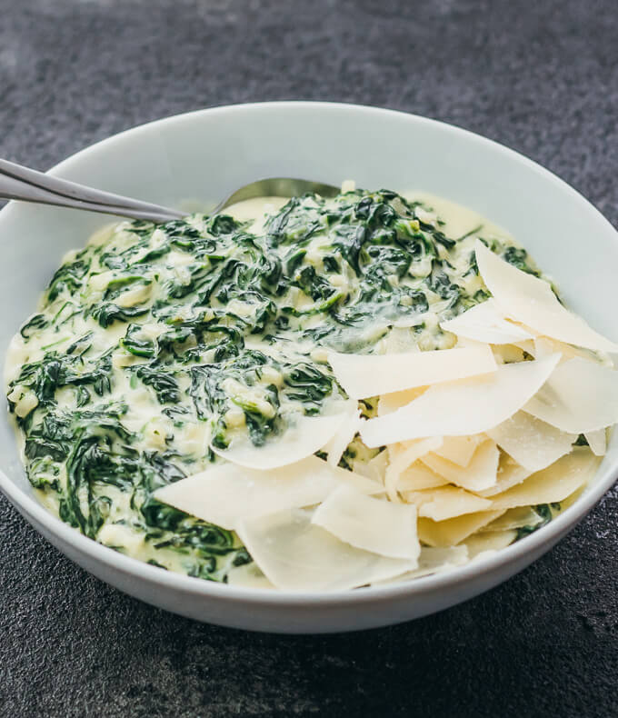 creamed spinach served in white bowl