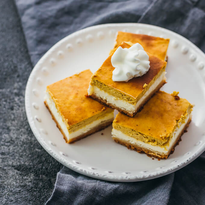 pumpkin cheesecake bars served on white plate