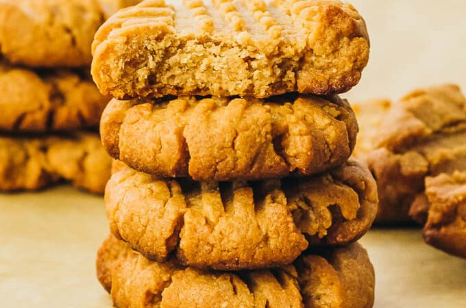 stack of peanut butter cookies, with a bite taken out
