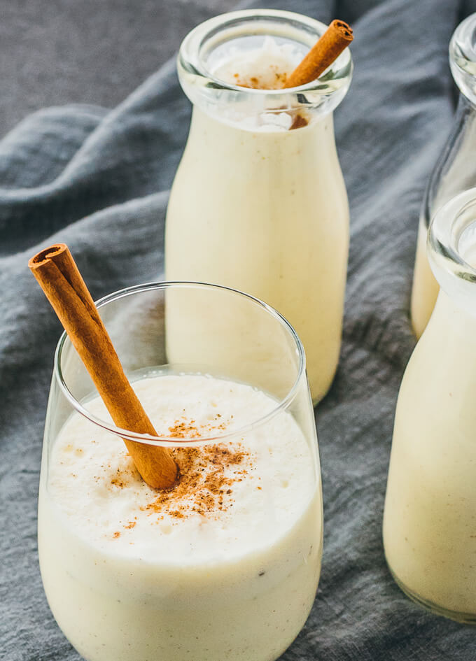 eggnog served in glass with cinnamon stick