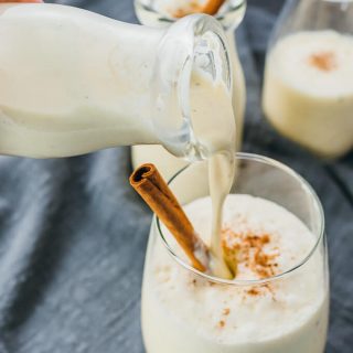 pouring eggnog into a glass