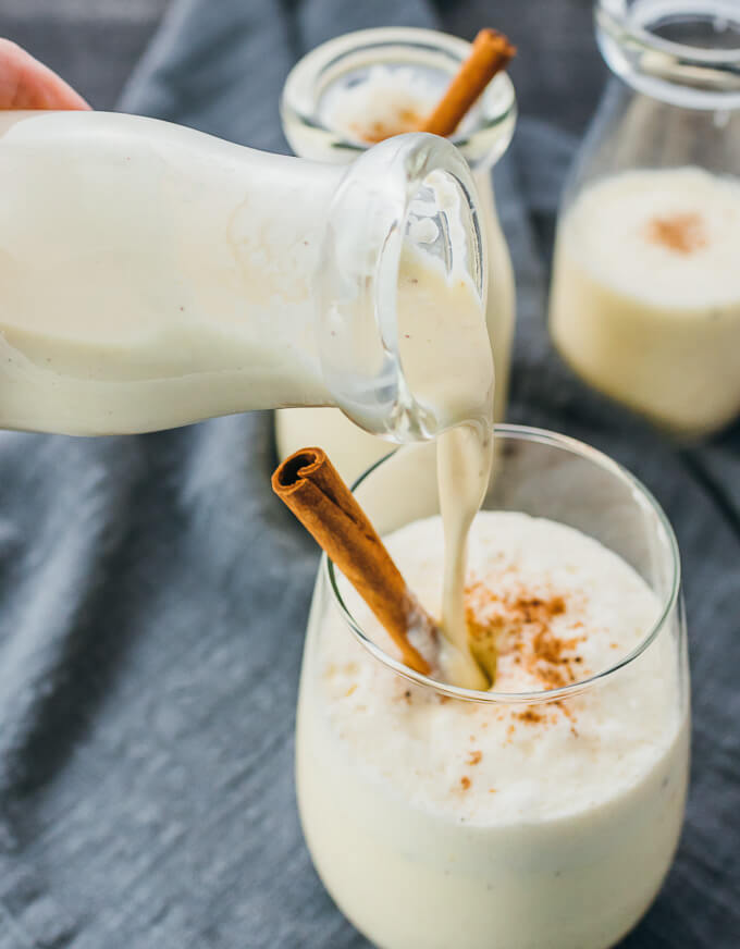 pouring eggnog into a glass