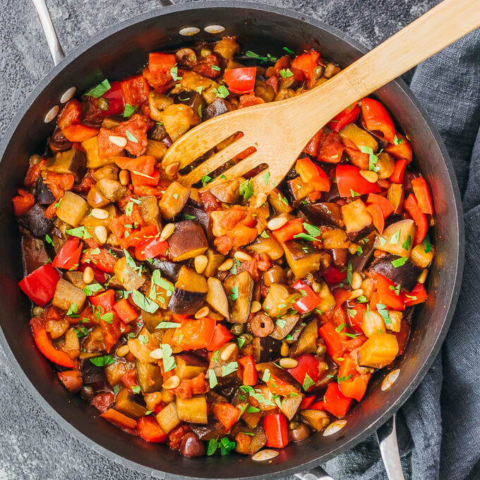 cooking eggplant caponata in black pan