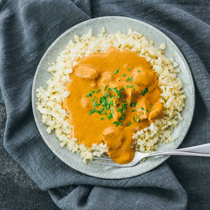 Crockpot recipe for chicken tikka masala served over rice in a small plate