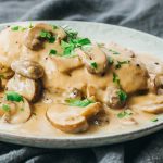 chicken topped with sliced mushrooms and gravy