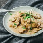 An Instant Pot chicken with creamy mushroom gravy served on a plate