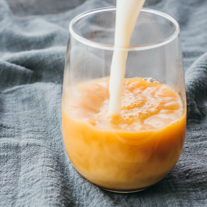 pouring milk into glass cup