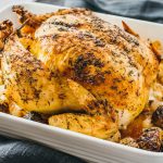 roast chicken with vegetables in casserole dish