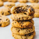 Tall stack of best low carb chocolate chip cookies, one with a bite taken out