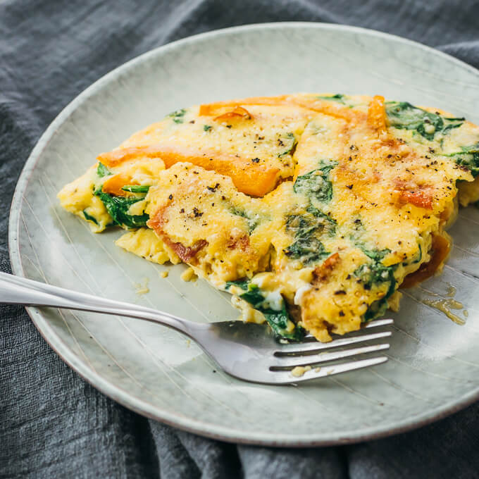 slice of spinach frittata served on plate