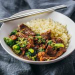Instant Pot beef and broccoli served in a white bowl with cauliflower rice