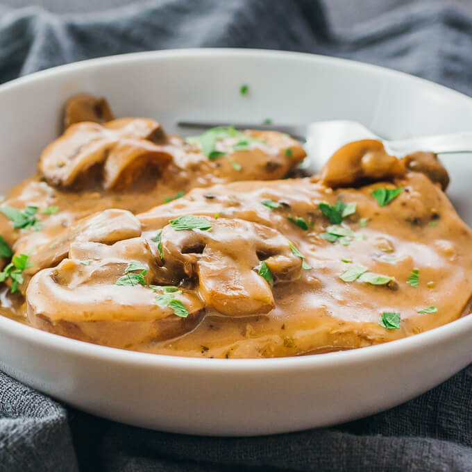 White bowl of best instant pot chicken marsala with easy creamy sauce