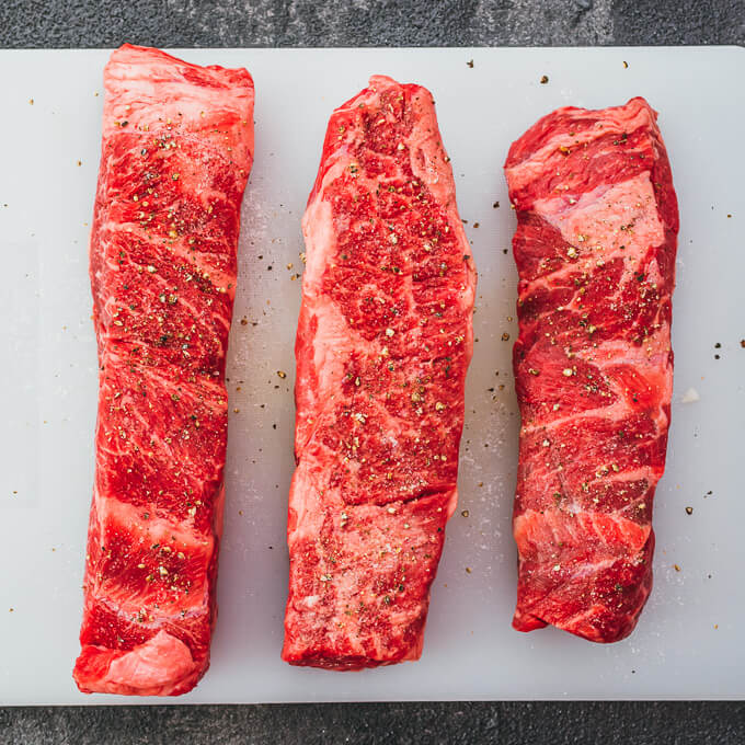 raw boneless beef short ribs on cutting board