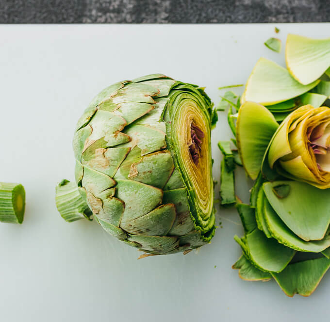 trimming off ends of artichoke