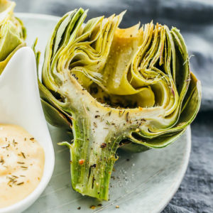 close up view of microwaved artichoke served on plate