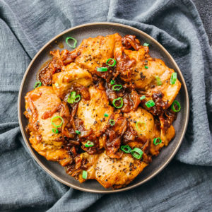 chicken adobo with onions served on plate