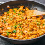 cooking tofu stir fry on black skillet