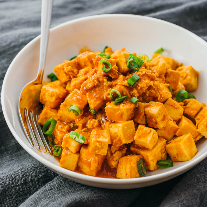 tofu stir fry with sauce served in white bowl