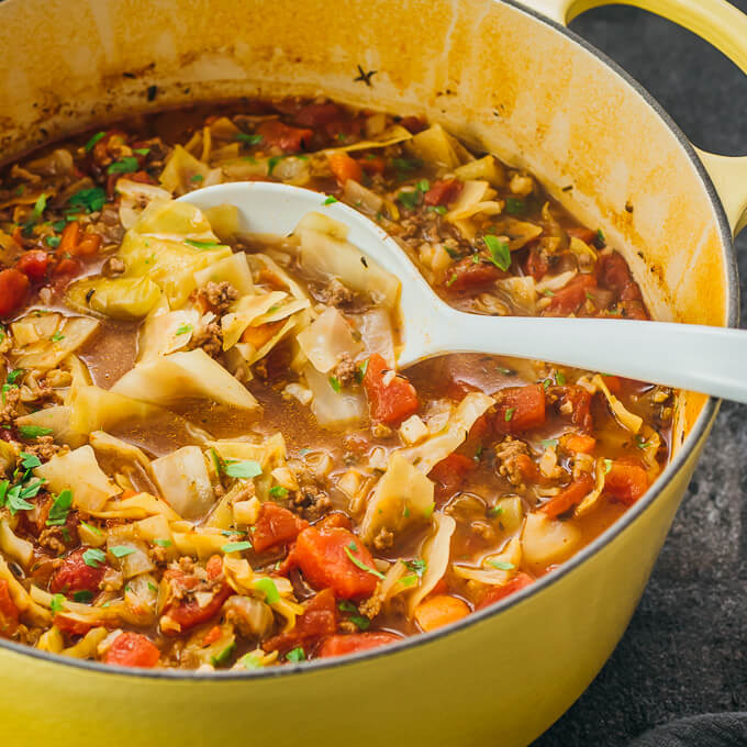 white ladle in cabbage soup