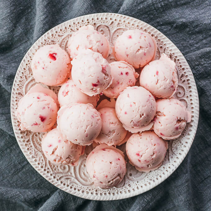 overhead view of strawberry fat bombs on white plate