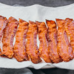 baked bacon slices on paper towel