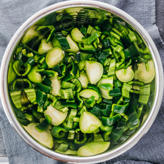 chopped peppers and tomatillos in pressure cooker