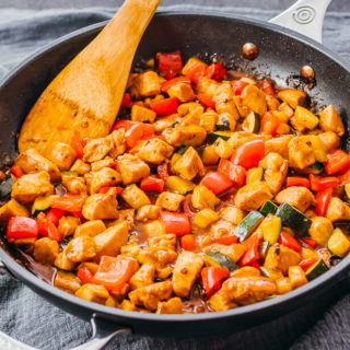 cooking kung pao chicken in black skillet