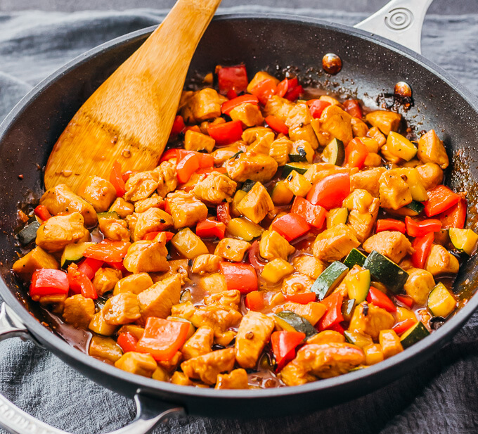 cooking kung pao chicken in black skillet