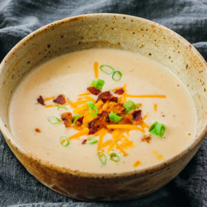 cauliflower cheese soup served in stoneware bowl