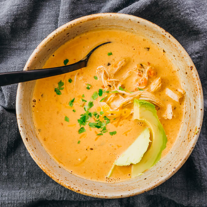 instant pot salsa chicken soup in a bowl topped with avocado
