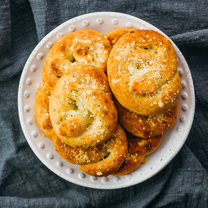 garlic knots piled up on white plate