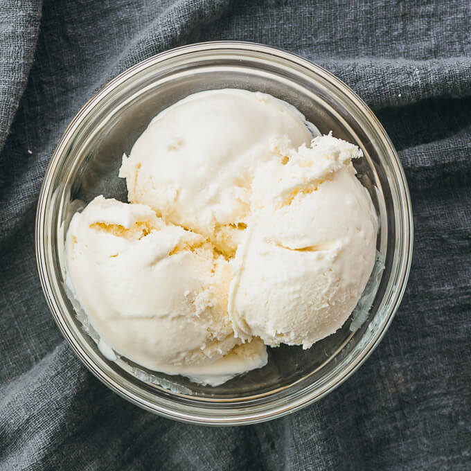 overhead view of ice cream scooped into glass bowl