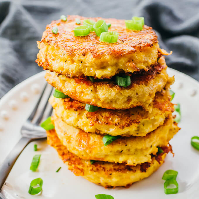 tall stack of cauliflower hash browns with scallions