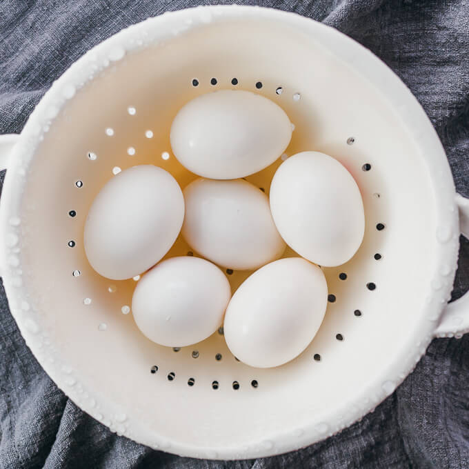 hard boiled eggs cooling in colander