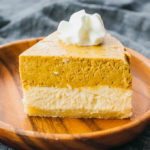 slice of pumpkin cheesecake on wooden plate