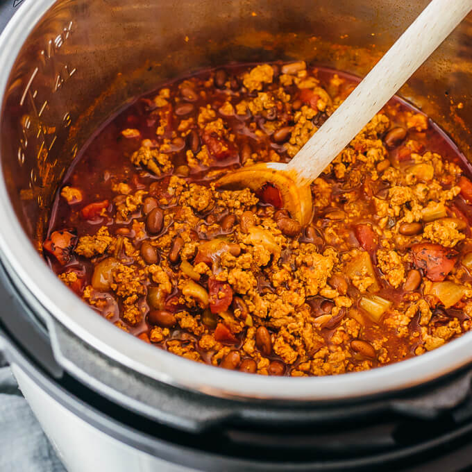 stirring low carb and keto chili made with ground turkey and ground beef