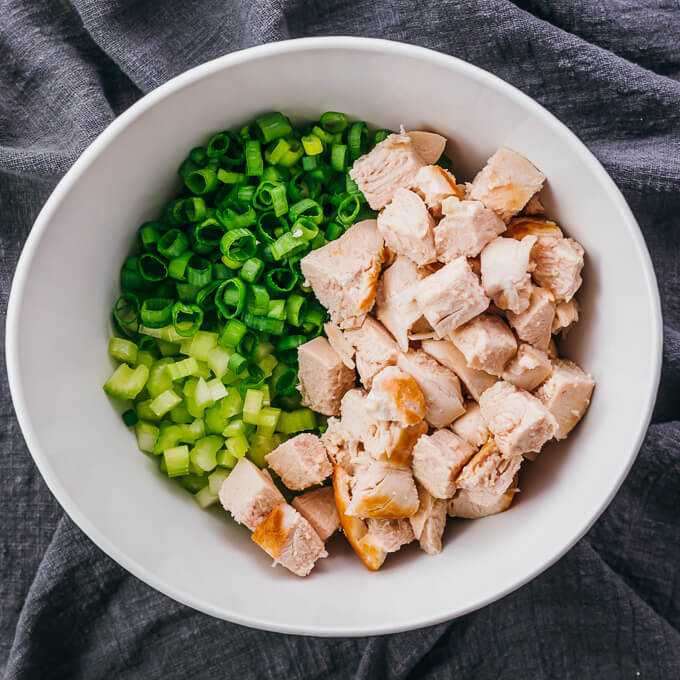 celery, scallions, and chicken in salad bowl