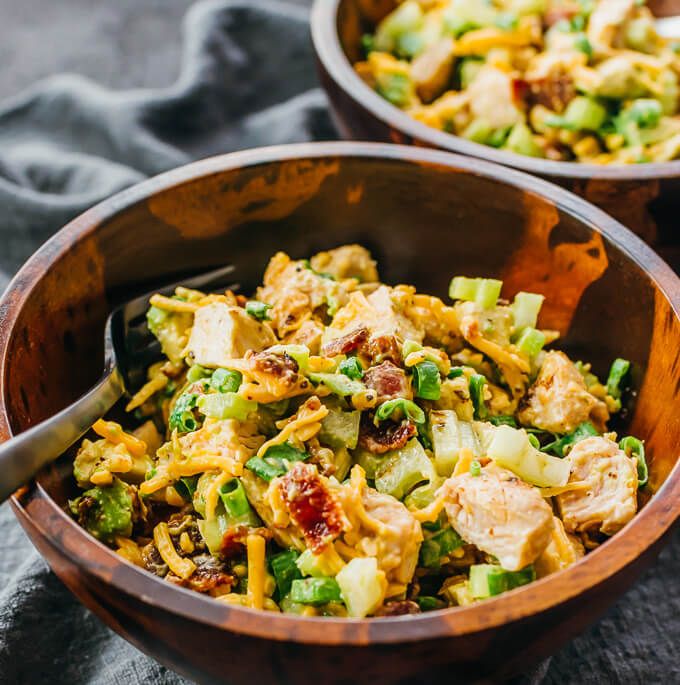 avocado bacon chicken salad served in wooden bowl