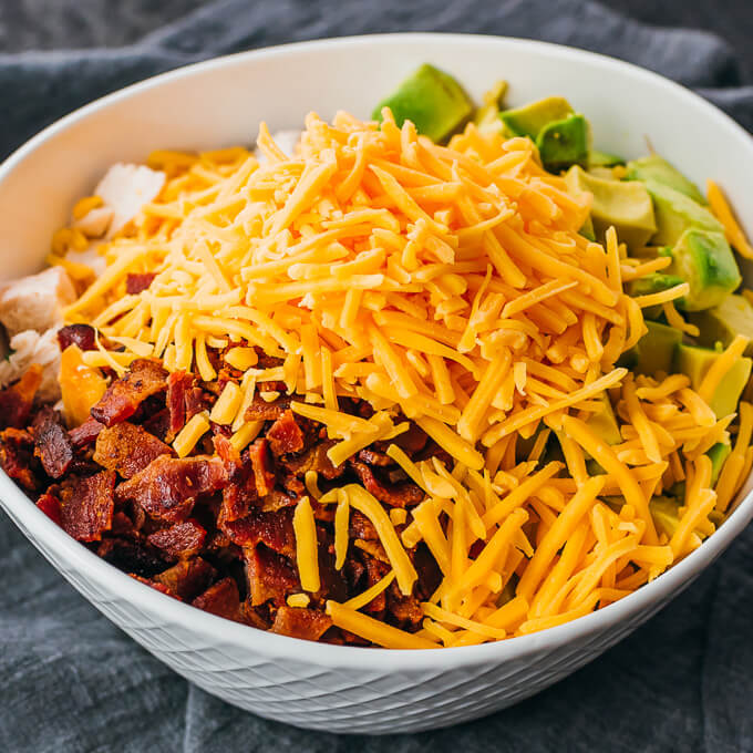 shredded cheddar cheese in keto salad bowl