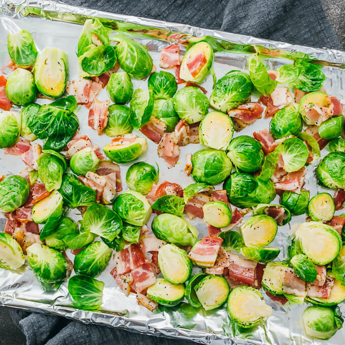 fresh brussels sprouts and bacon on baking sheet