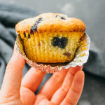 close up view of keto blueberry muffin with wrapper open