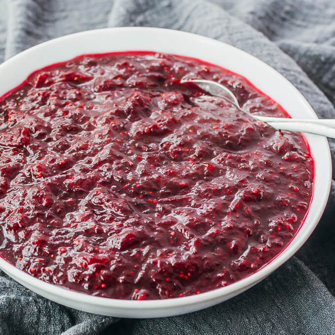 instant pot cranberry sauce with orange zest in white bowl