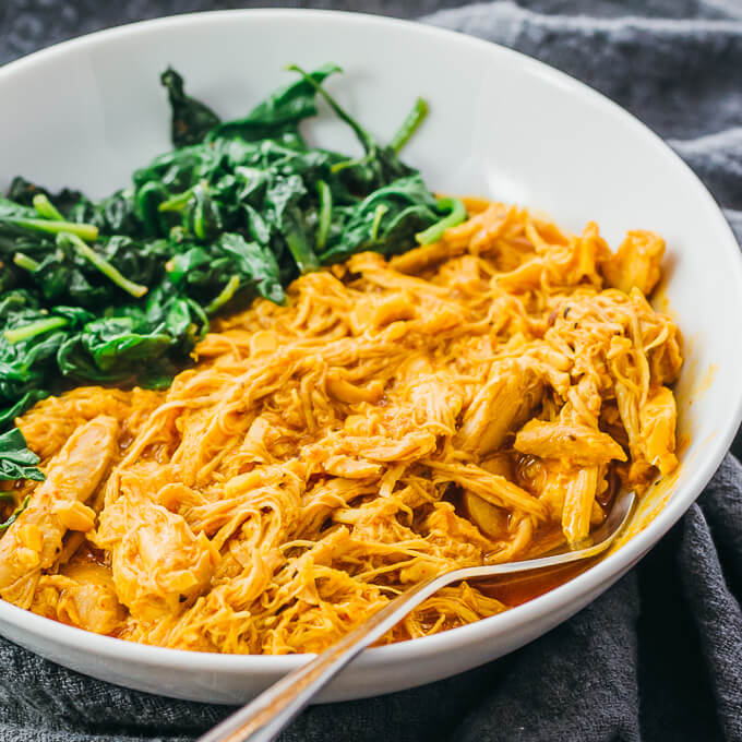 tandoori chicken served with spinach in white bowl