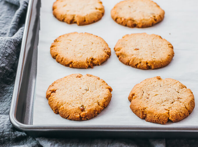 pecan sandies on cooking sheet after baking