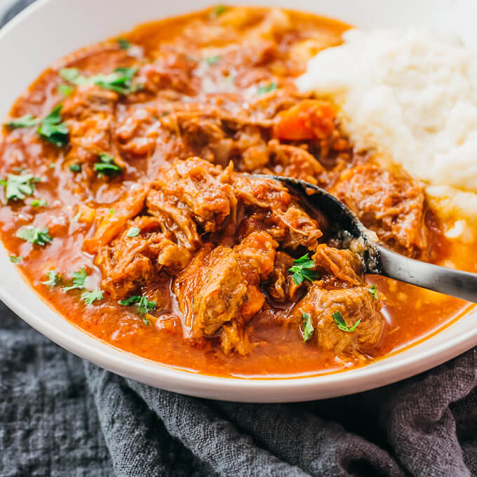 close up view of beef ragu in white bowl