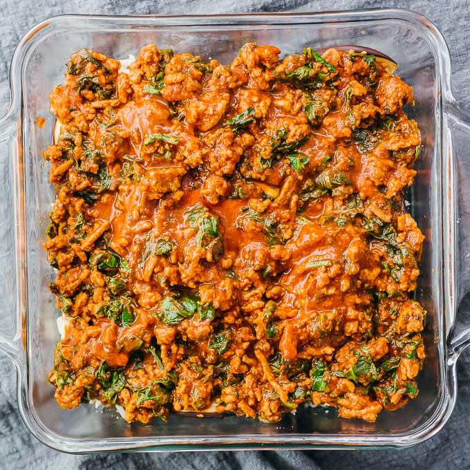 adding meat sauce to eggplant lasagna