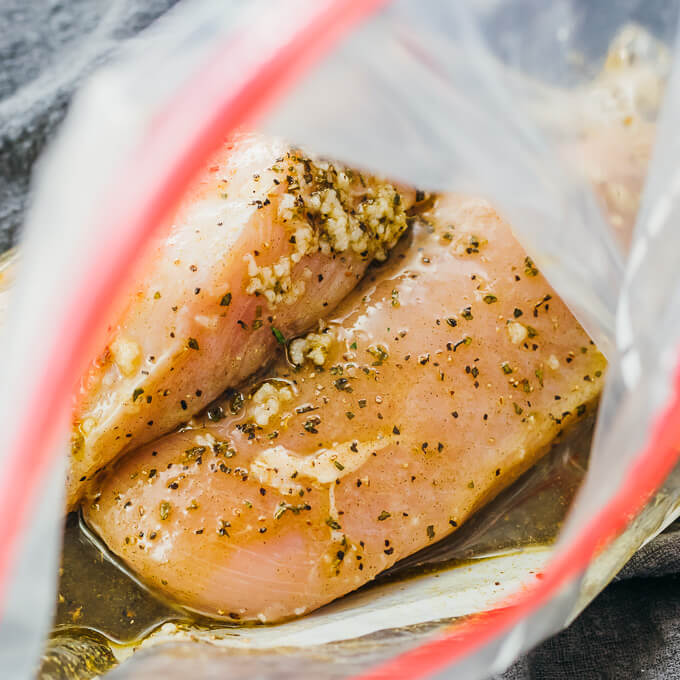 close up view of chicken soaking in marinade