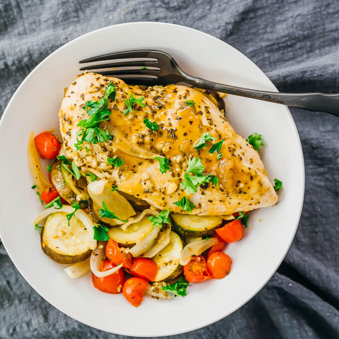 baked chicken and vegetables in white bowl