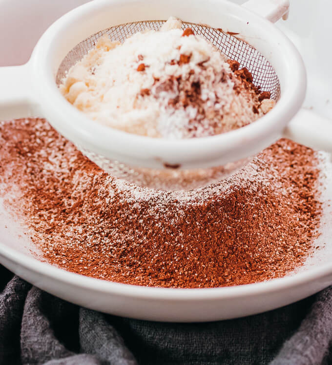 sifting coconut flour and cocoa powder